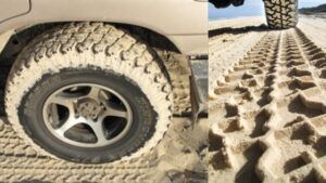 Close ups of tyres at different pressures on the beach